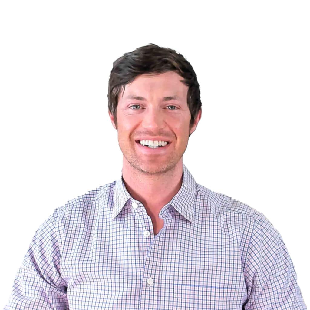 dr. westin childs sitting down smiling in a button up shirt.